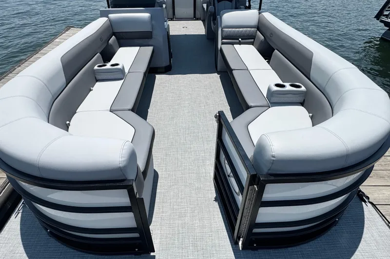 Slide: The Image of 2026 Veranda Vista Sport VS25RC pontoon boat with luxurious seating on a sunny day. - 4