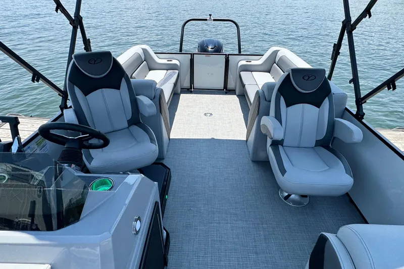 Slide: The Image of 2026 Veranda Vista Sport VS25RC pontoon boat interior with plush seating on a calm lake. - 5