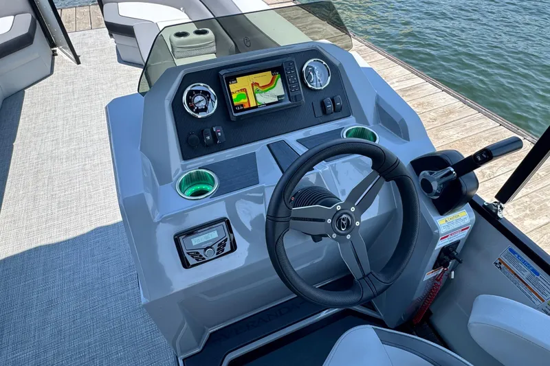 Slide: The Image of 2026 Veranda Vista Sport VS25RC boat dashboard with steering wheel and navigation display. - 7