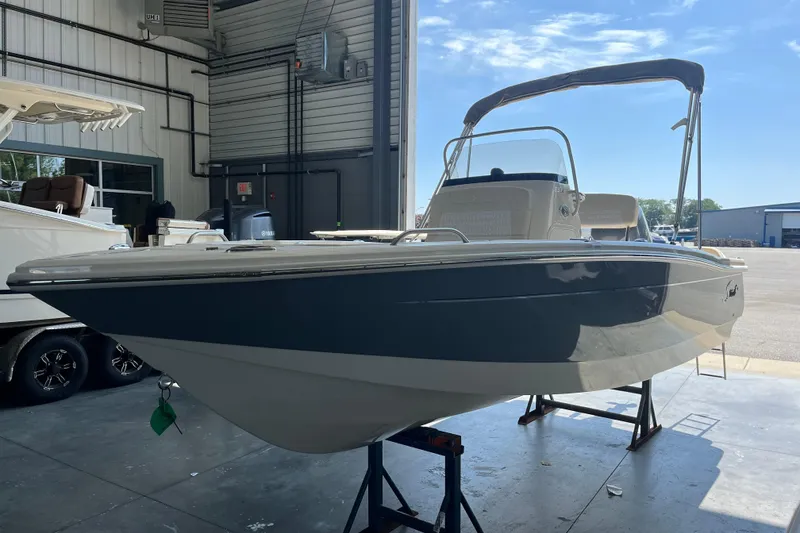 Slide: The Image of 2026 Scout 188 Sportfish boat displayed in a showroom. - 0