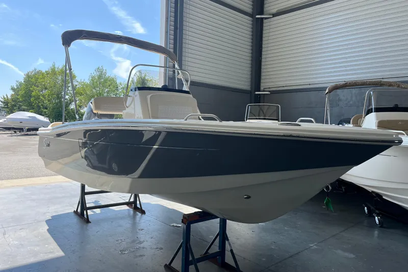 Slide: The Image of 2026 Scout 188 Sportfish boat displayed indoors at a showroom. - 3