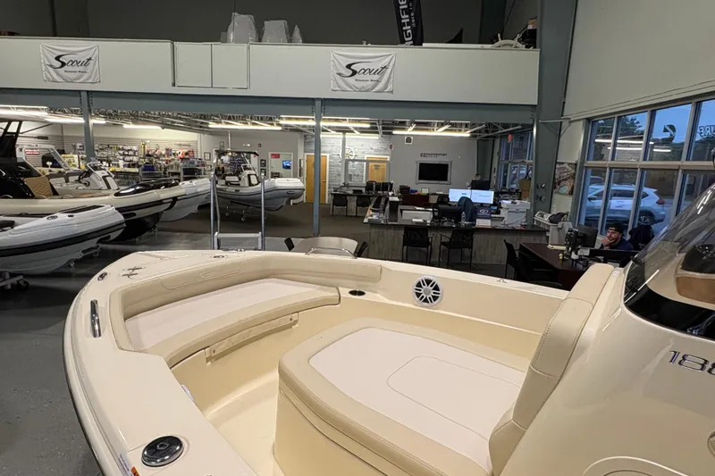 Slide: The Image of 2026 Scout 188 Sportfish boat displayed in a showroom with other boats. - 7