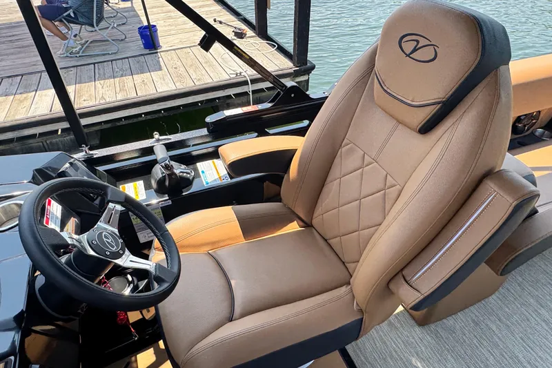 Slide: The Image of Captain's chair and steering wheel of 2026 Veranda Vertex VX285DCRC boat at dock. - 11