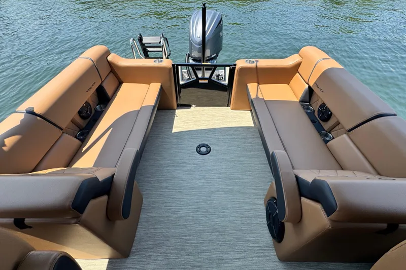 Slide: The Image of Luxurious Veranda Vertex VX285DCRC pontoon boat interior, 2026 model, with tan seating on water. - 13