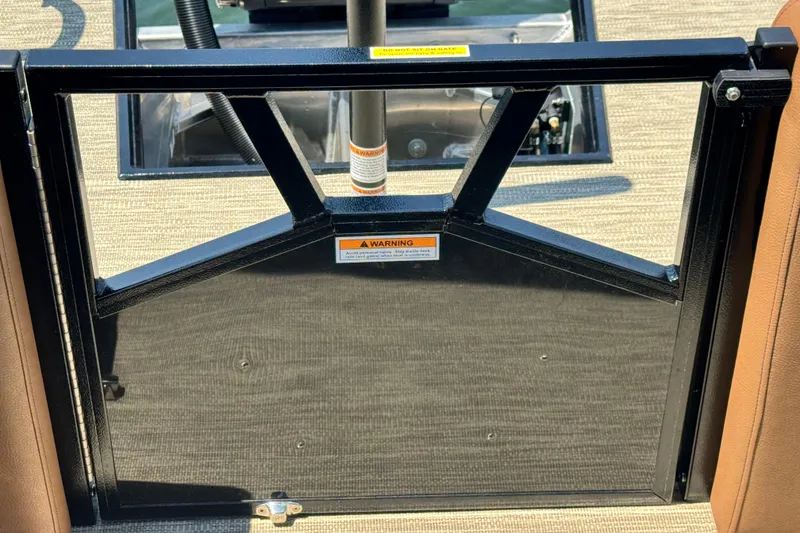 Slide: The Image of 2026 Veranda Vertex VX285DCRC boat gate with warning label and beige flooring. - 15