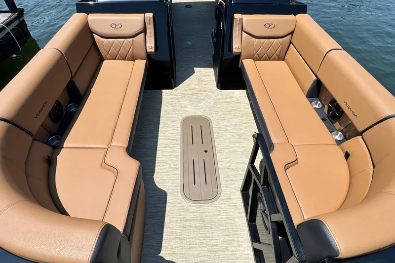 Slide: The Image of Luxurious seating on 2026 Veranda Vertex VX285DCRC pontoon boat, featuring tan upholstery and cup holders. - 5