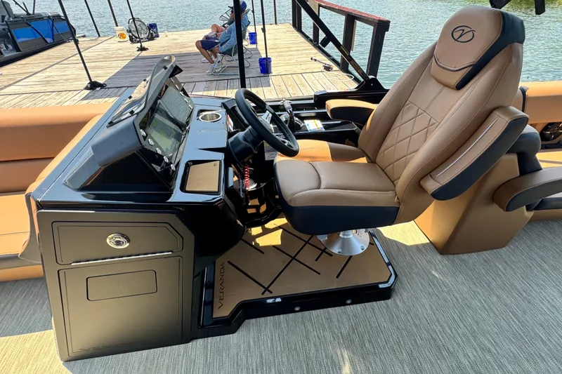 Slide: The Image of Luxurious helm of 2026 Veranda Vertex VX285DCRC pontoon boat with plush seating. - 8