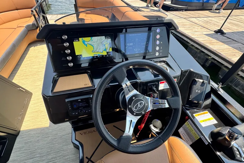 Slide: The Image of 2026 Veranda Vertex VX285DCRC boat dashboard with navigation screens and steering wheel. - 9