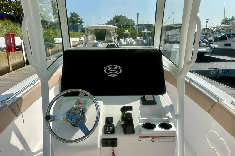 Slide: The Image of 2020 Sportsman Heritage 251 Center Console boat interior with steering wheel and controls. - 10