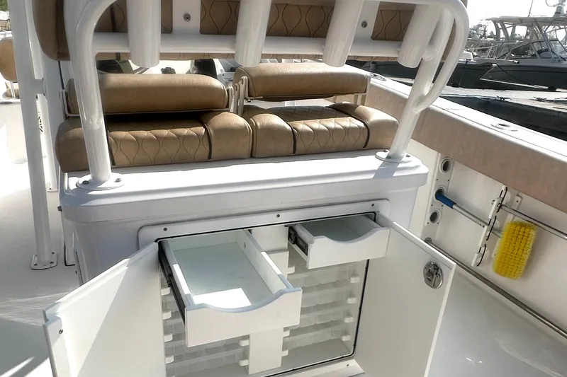 Slide: The Image of 2020 Sportsman Heritage 251 Center Console with open storage compartments and cushioned seating. - 11