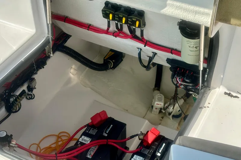 Slide: The Image of 2020 Sportsman Heritage 251 Center Console boat electrical compartment with batteries and wiring. - 14