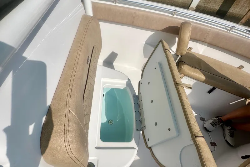 Slide: The Image of 2020 Sportsman Heritage 251 Center Console interior with open storage compartment and beige seating. - 17