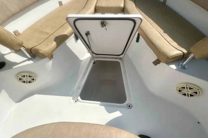 Slide: The Image of 2020 Sportsman Heritage 251 Center Console boat interior with open storage compartment. - 18