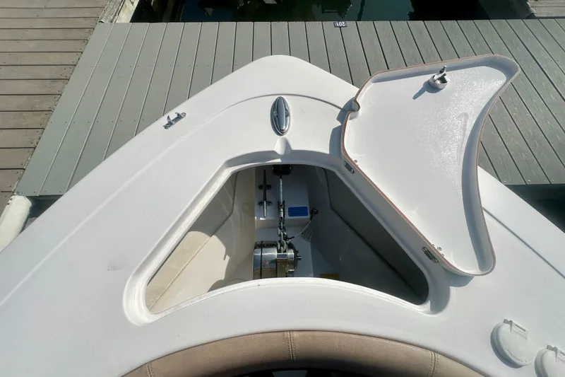 Slide: The Image of 2020 Sportsman Heritage 251 Center Console boat with open anchor locker at dock. - 19