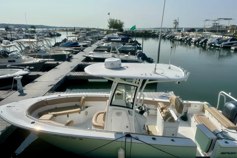Slide: The Image of 2020 Sportsman Heritage 251 Center Console boat docked at a marina. - 3