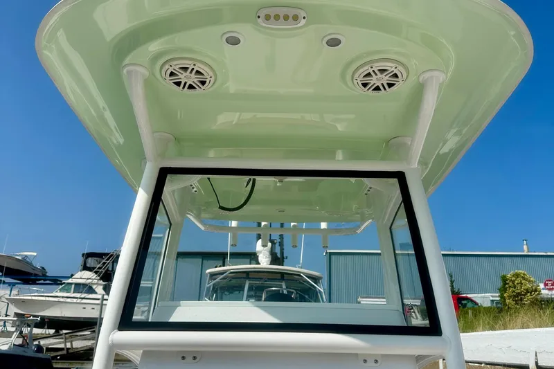 Slide: The Image of 2020 Sportsman Heritage 251 Center Console boat with T-top and speakers. - 5