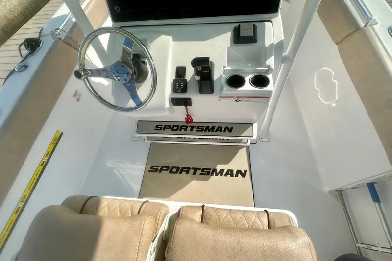Slide: The Image of 2020 Sportsman Heritage 251 Center Console boat interior with steering wheel and controls. - 8
