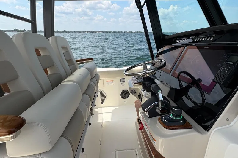 Slide: The Image of Interior view of 2025 Boston Whaler 360 Outrage boat cockpit with modern controls. - 11