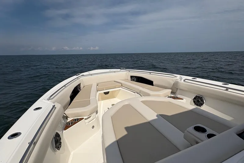 Slide: The Image of 2025 Boston Whaler 360 Outrage boat interior with ocean view, featuring spacious seating. - 15