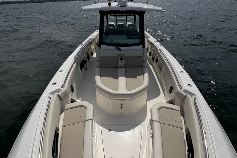 Slide: The Image of 2025 Boston Whaler 360 Outrage boat with spacious seating on open water. - 17