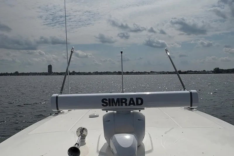 Slide: The Image of Boston Whaler 360 Outrage 2025 on water, featuring Simrad radar system. - 18