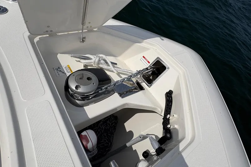 Slide: The Image of Anchor compartment of 2025 Boston Whaler 360 Outrage, featuring chain and rope storage. - 19