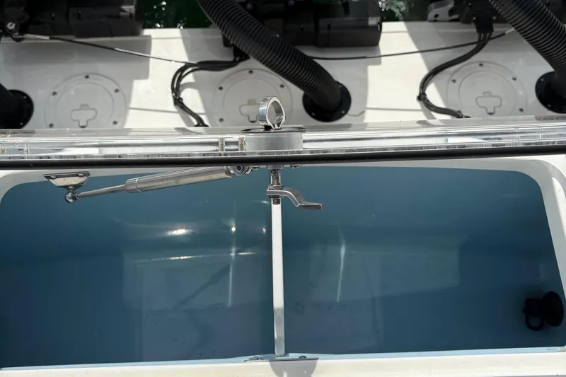 Slide: The Image of 2025 Boston Whaler 360 Outrage livewell with open lid and water hose. - 6