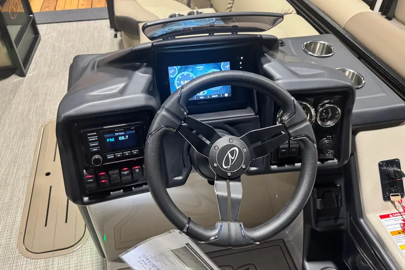 Slide: The Image of 2026 Veranda Relax VR235RCP boat dashboard with steering wheel and digital display. - 6