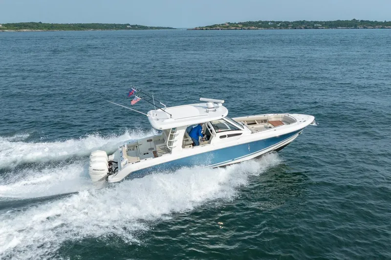 The Image of 2019 Boston Whaler 350 EX REALM cruising on open water, showcasing sleek design and performance. - 0