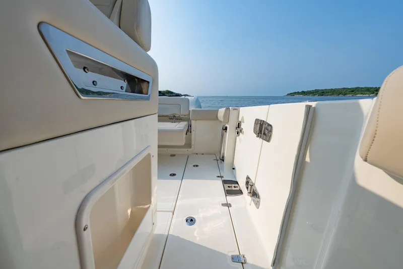 Slide: The Image of 2019 Boston Whaler 350 EX REALM boat interior with ocean view and sleek design. - 16