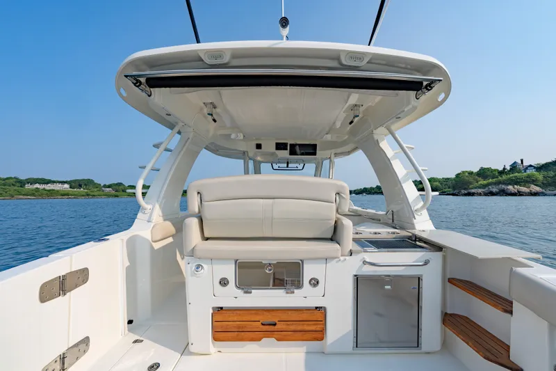 Slide: The Image of 2019 Boston Whaler 350 EX REALM boat interior with seating and ocean view. - 19