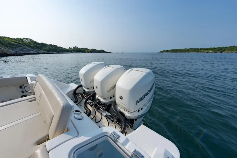 Slide: The Image of 2019 Boston Whaler 350 EX REALM with triple Mercury engines on calm water. - 24