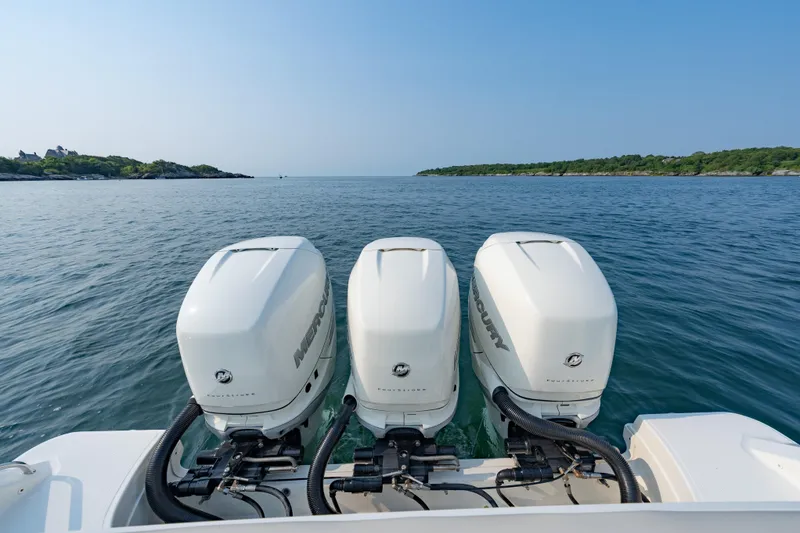 Slide: The Image of 2019 Boston Whaler 350 EX REALM with triple Mercury outboard engines on open water. - 25