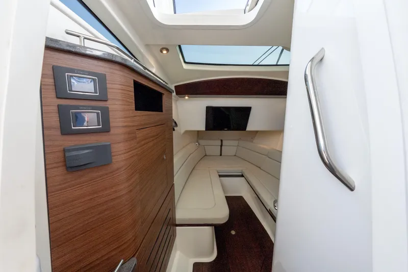 Slide: The Image of 2019 Boston Whaler 350 EX REALM cabin interior with wood paneling and seating. - 33