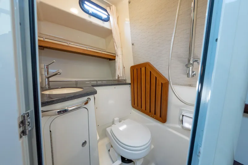 Slide: The Image of 2019 Boston Whaler 350 EX REALM bathroom with sink, toilet, and shower. - 36