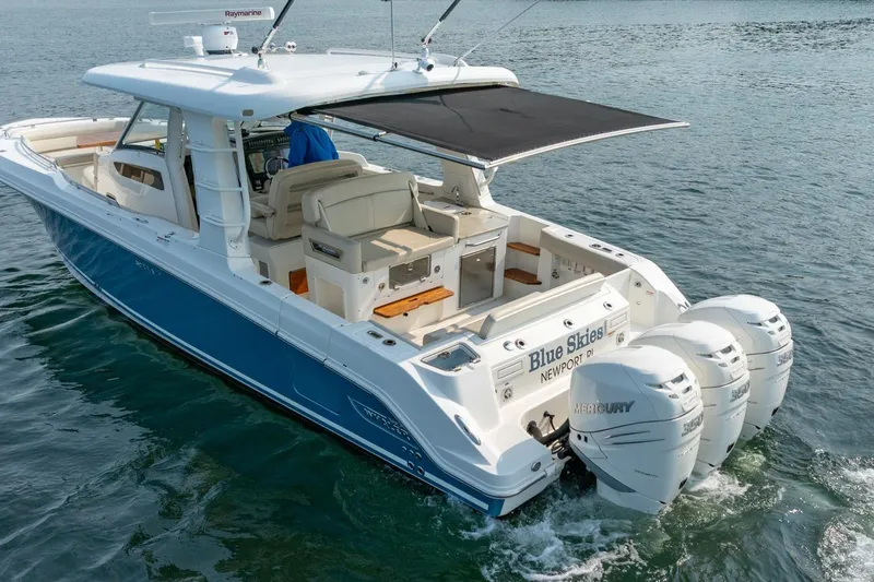 Slide: The Image of 2019 Boston Whaler 350 EX REALM boat with triple Mercury engines on the water. - 38