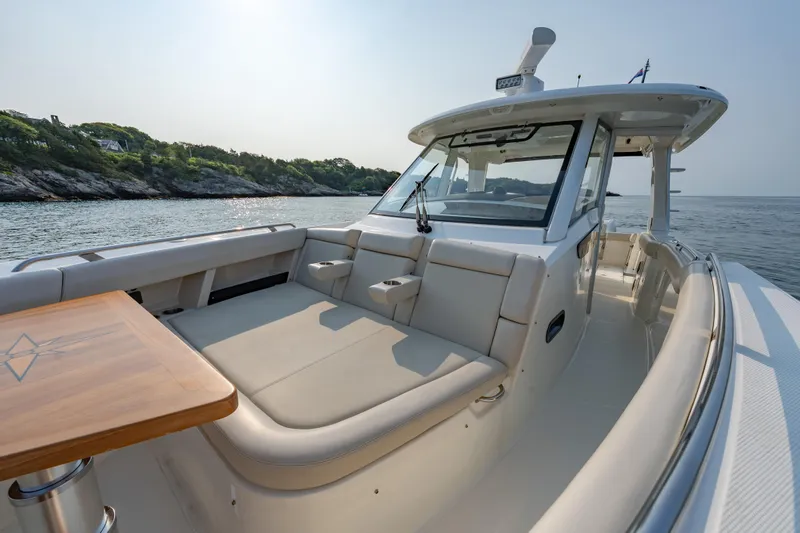 Slide: The Image of 2019 Boston Whaler 350 EX REALM boat with luxurious seating, cruising on calm waters. - 5