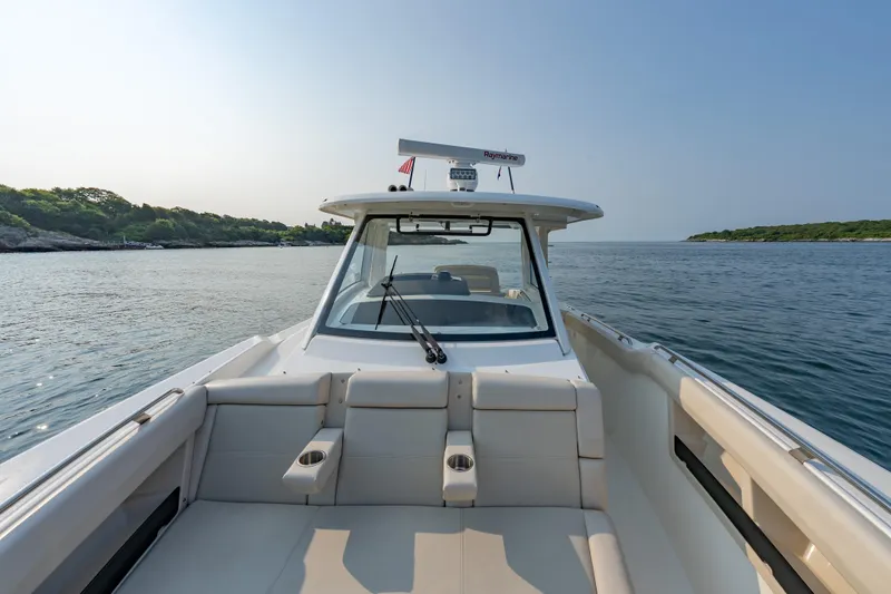 Slide: The Image of 2019 Boston Whaler 350 EX REALM boat cruising on calm waters. - 6