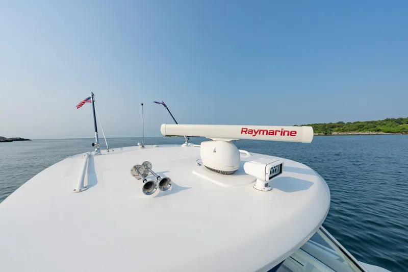 Slide: The Image of 2019 Boston Whaler 350 EX REALM boat with Raymarine radar on calm water. - 8