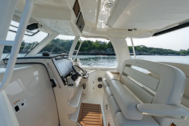 Slide: The Image of Interior view of 2019 Boston Whaler 350 EX REALM boat with helm and seating. - 9