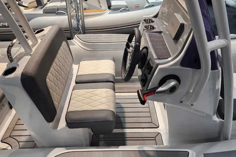 Slide: The Image of Interior of a 2026 Gala V500 boat with gray and white seating. - 6