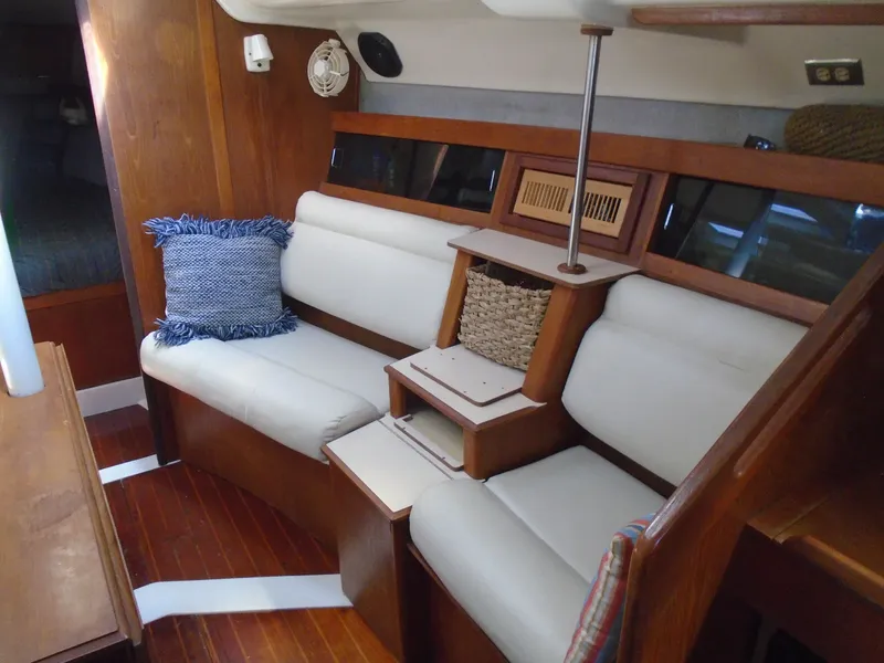 Slide: The Image of Interior of 1987 Hunter Legend 37 sailboat with white seating and wooden accents. - 3