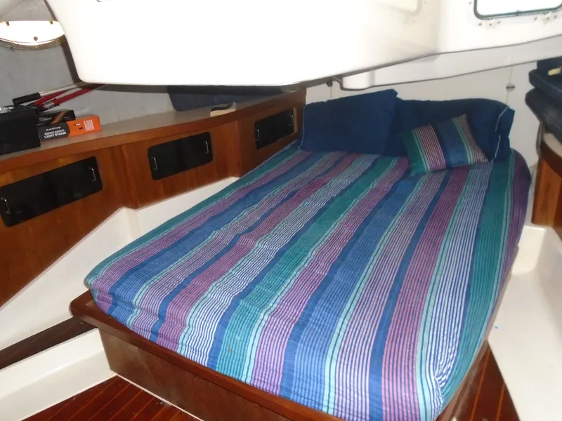 Slide: The Image of Cozy cabin interior of 1987 Hunter Legend 37 sailboat with striped bedding. - 7