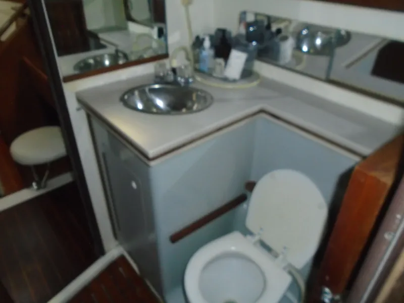 Slide: The Image of 1987 Hunter Legend 37 yacht bathroom with sink, mirror, and toilet. - 8