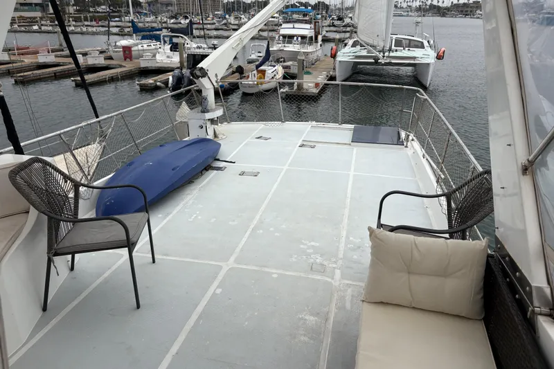 Slide: The Image of Spacious deck of 1990 Angel Pilothouse yacht with seating and marina view. - 16