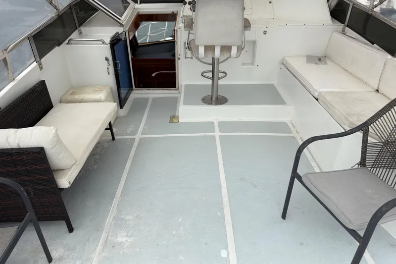 Slide: The Image of 1990 Angel Pilothouse boat interior with seating and helm station. - 17