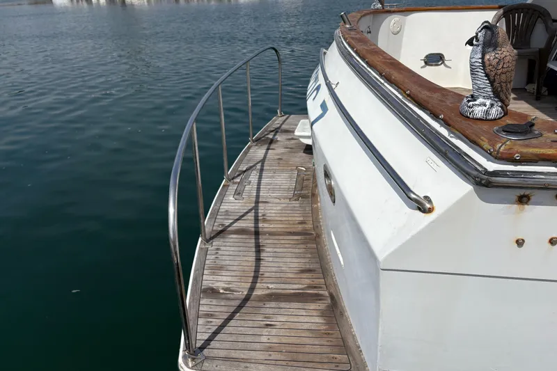 Slide: The Image of 1990 Angel Pilothouse boat with wooden deck and decorative owl statue. - 20
