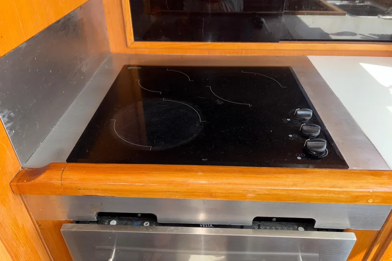 Slide: The Image of Electric stove in 1990 Angel Pilothouse kitchen with wooden trim. - 23