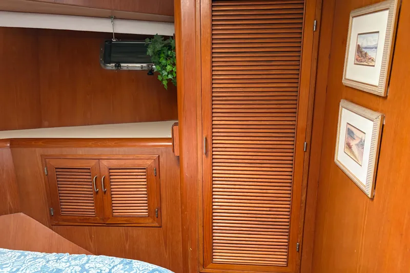 Slide: The Image of Interior of 1990 Angel Pilothouse with wooden cabinets and framed artwork. - 6