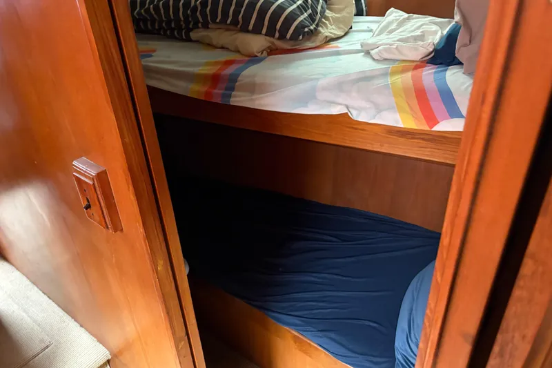 Slide: The Image of Bunk beds in 1990 Angel Pilothouse boat cabin with colorful bedding. - 8